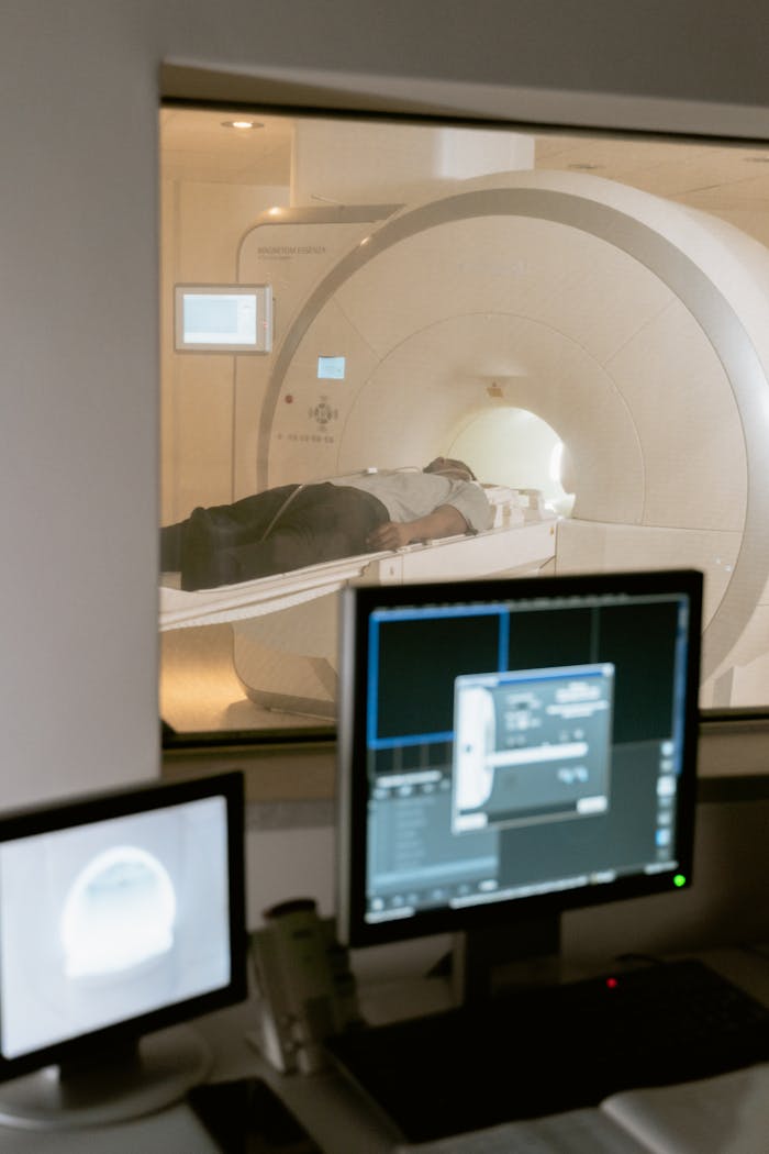 Modern MRI scanner in a medical facility featuring patient and monitoring equipment.
